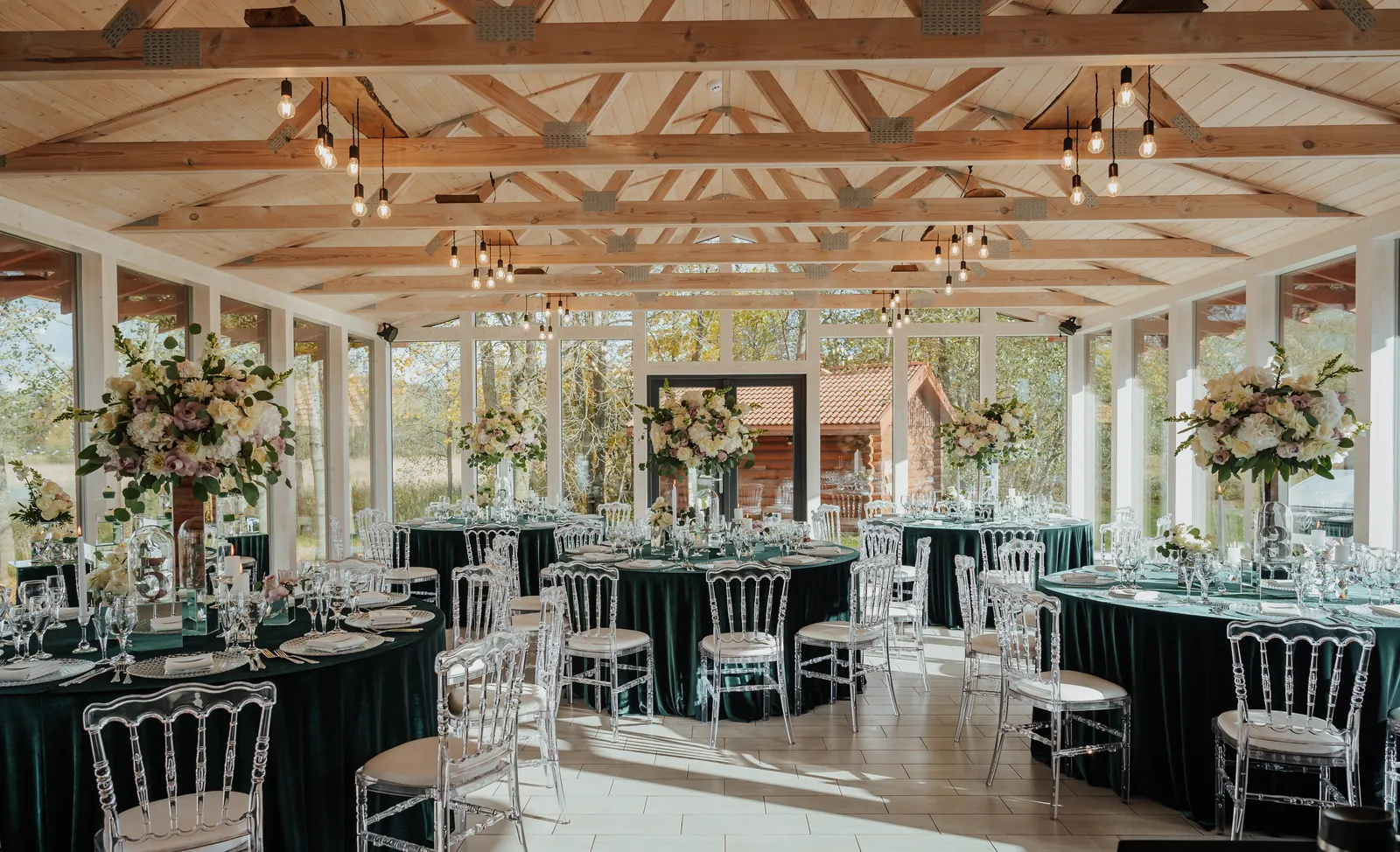 A light-filled wedding reception room with tables ready for the celebration.